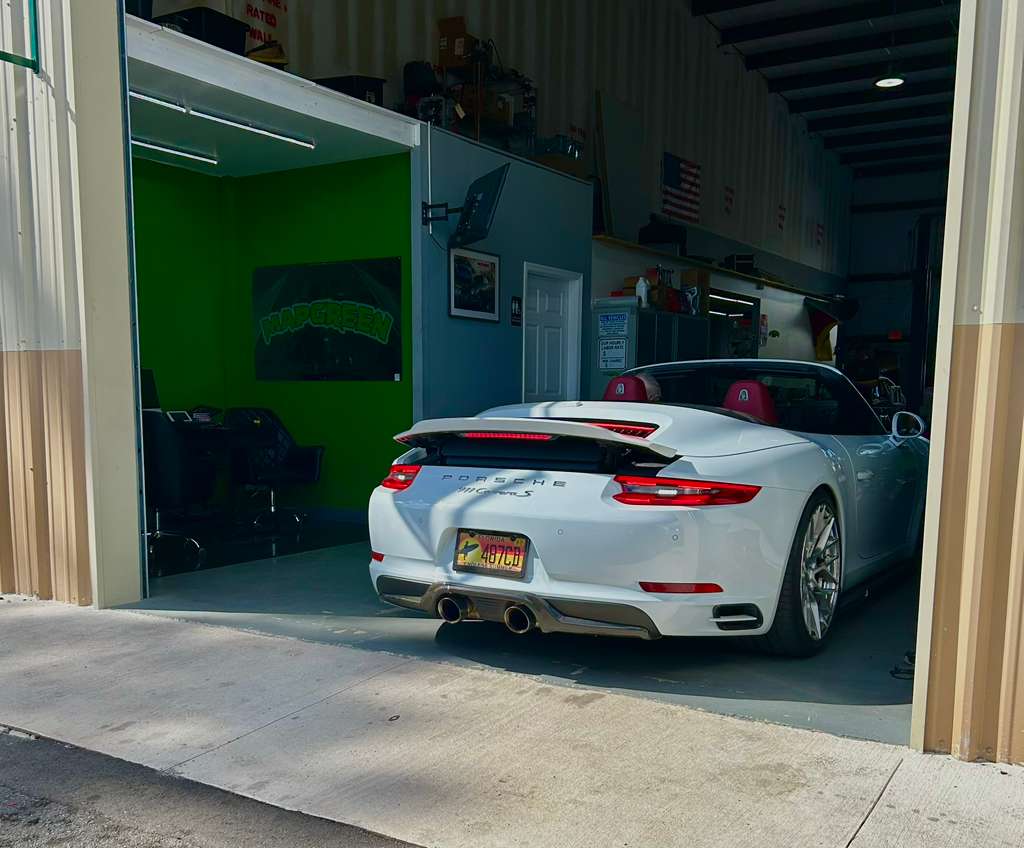 White sports car parked at the Mapgreen shop entrance