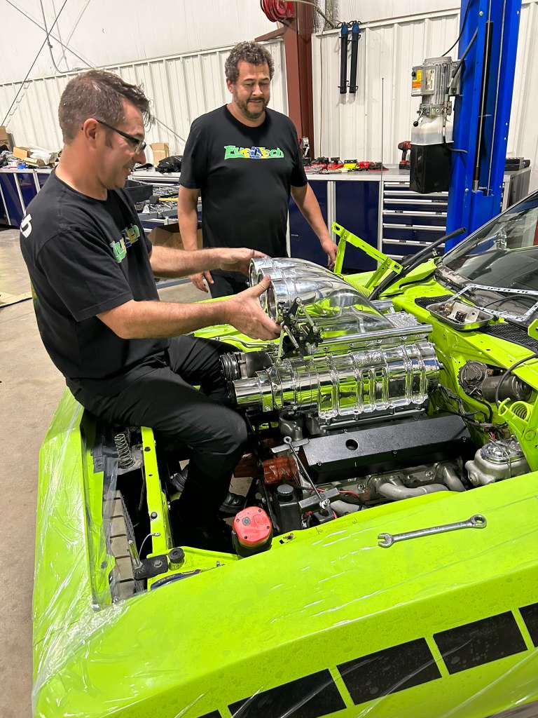 Mapgreen technicians working on a green performance car